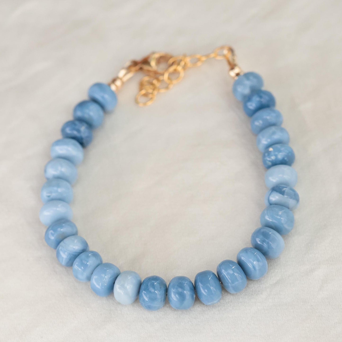 Blue Opal bracelet by Earthly Abundance featuring polished blue opal beads on a delicate elastic cord.