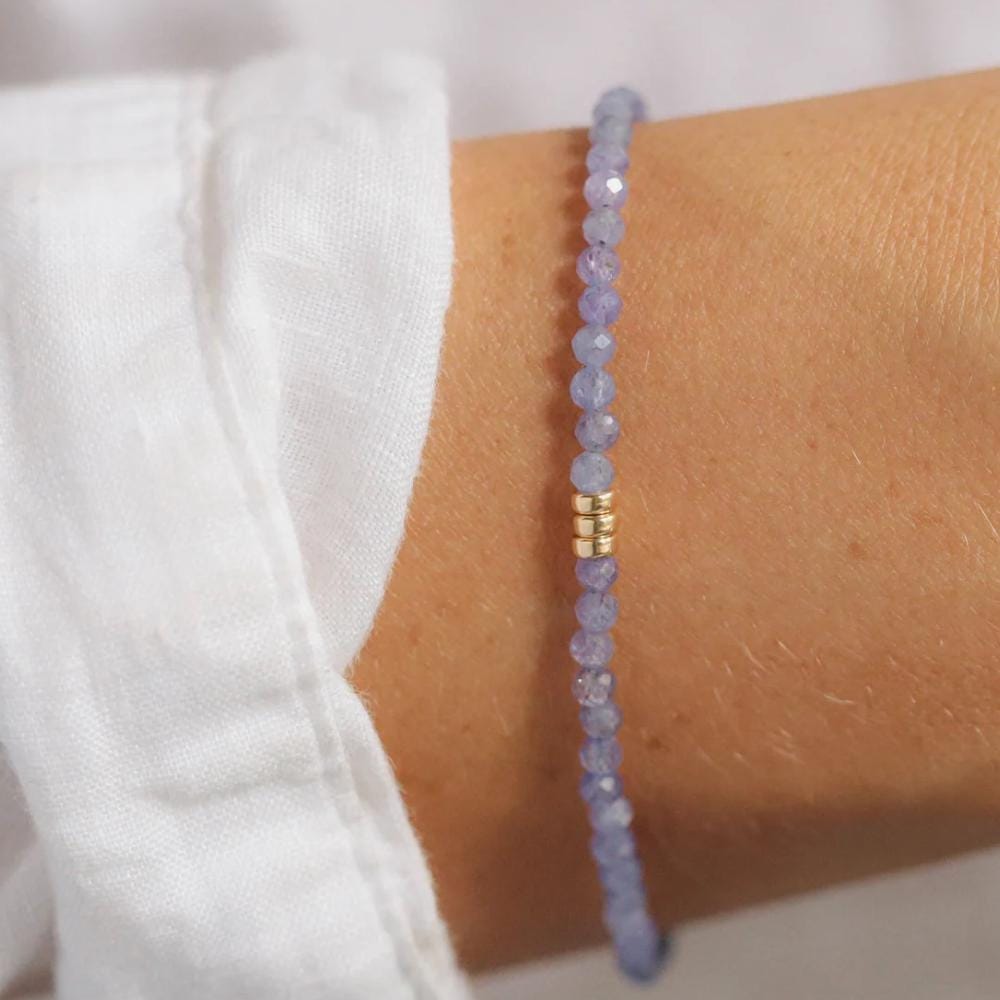 3mm AAA Tanzanite bracelet by Earthly Abundance featuring vibrant blue tanzanite gemstones on a delicate string.