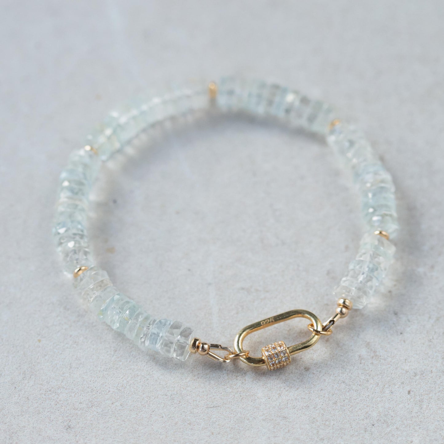 White topaz carabiner bracelet by Earthly Abundance featuring sparkling gemstones and a secure metal clasp.
