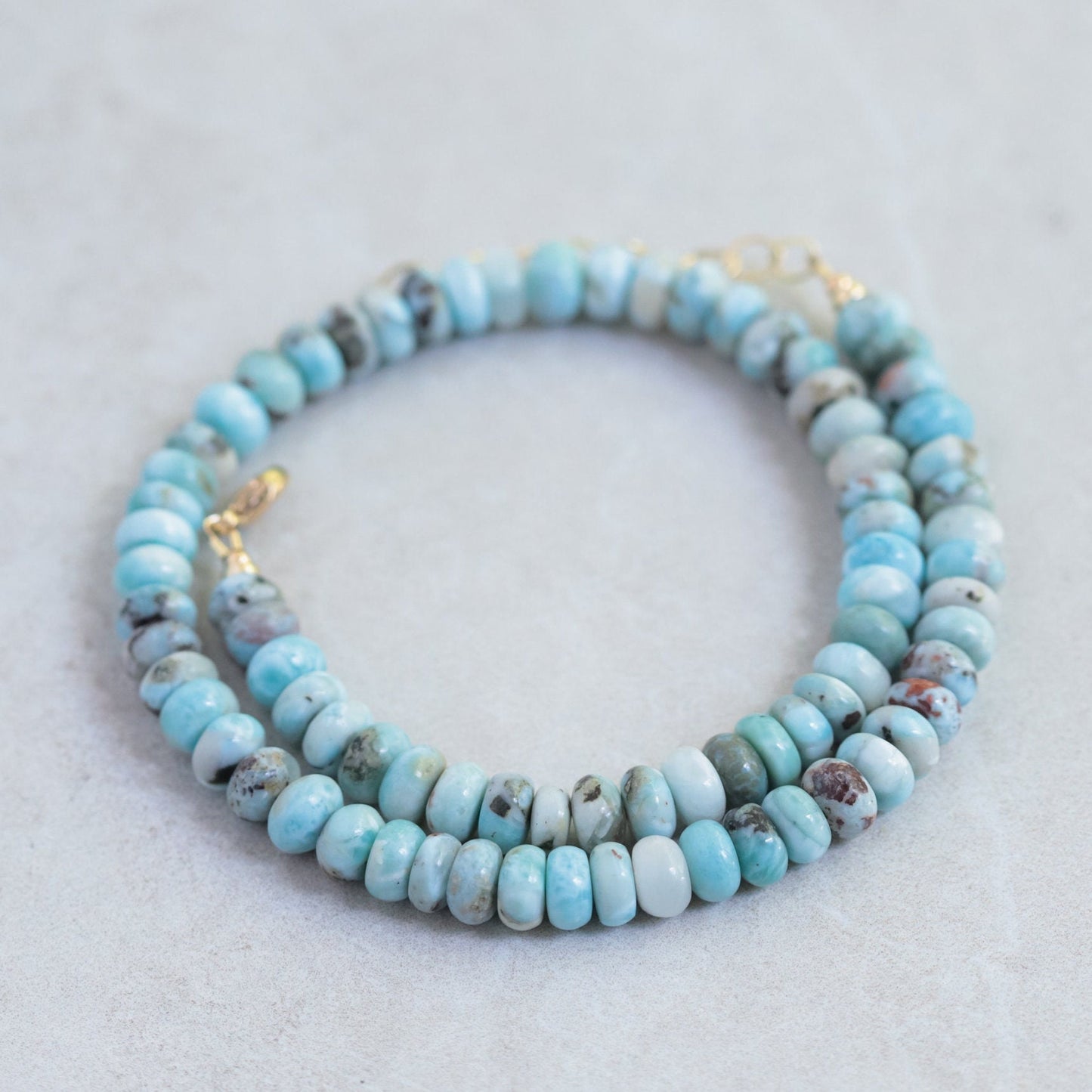 Candy Larimar necklace featuring a polished blue larimar pendant on a silver chain, displayed against a neutral background.