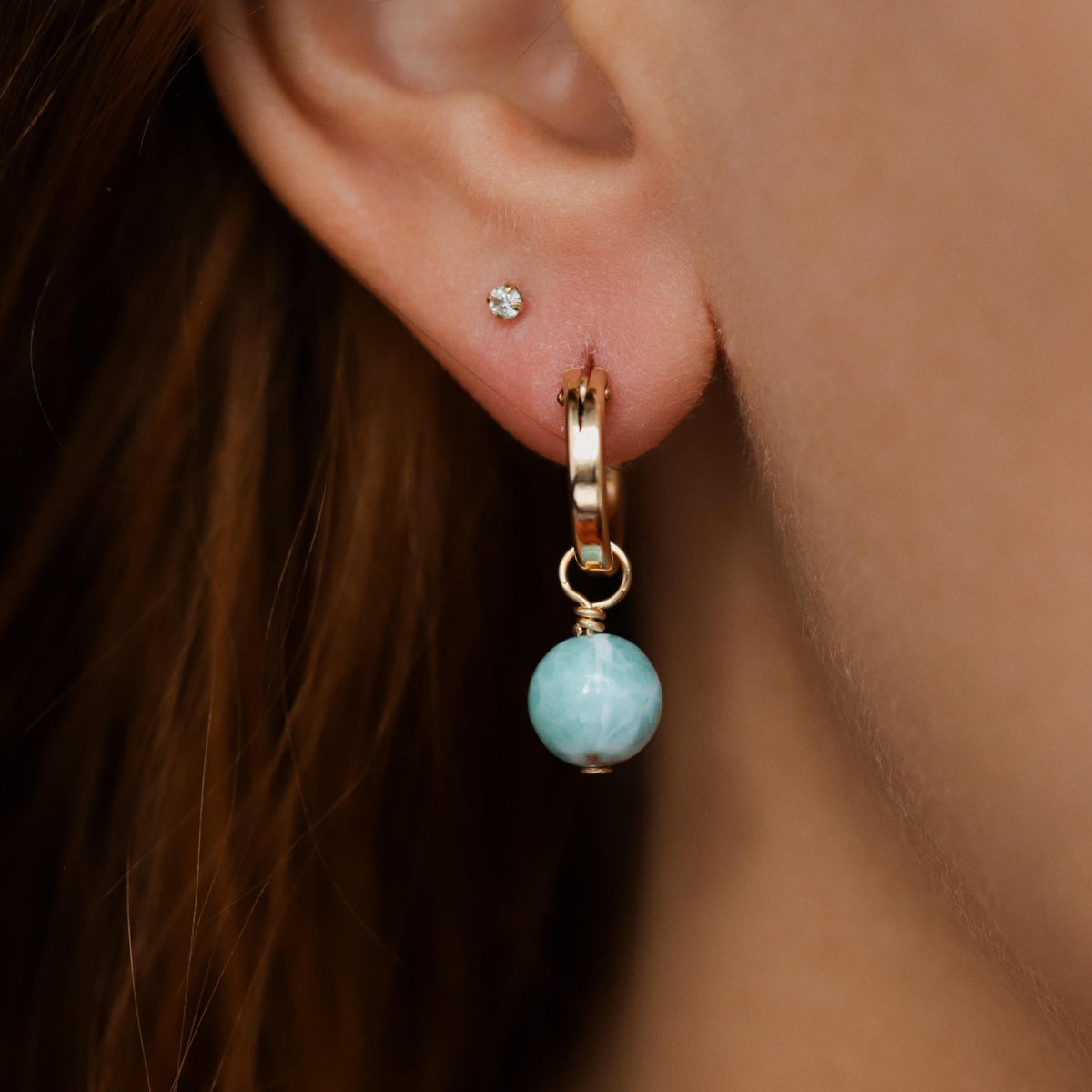 Larimar gemstone hoop earrings in 14K gold filled, featuring vibrant blue stones and elegant hoop design.