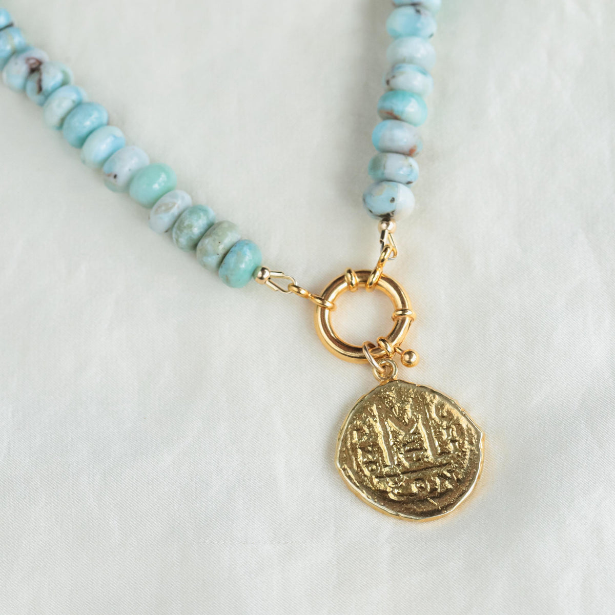 Larimar toggle necklace by Earthly Abundance featuring a polished blue gemstone pendant on a silver chain.