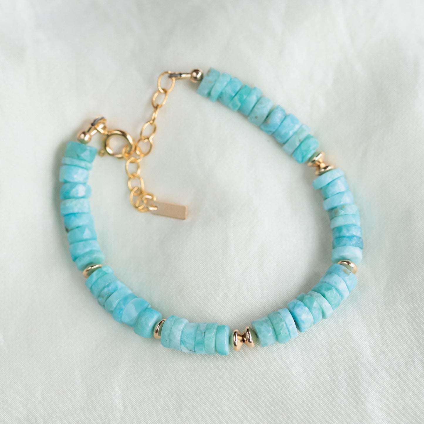 Larimar Heishi bracelet with 14K gold-filled accents, featuring smooth blue stone beads, crafted by Earthly Abundance.