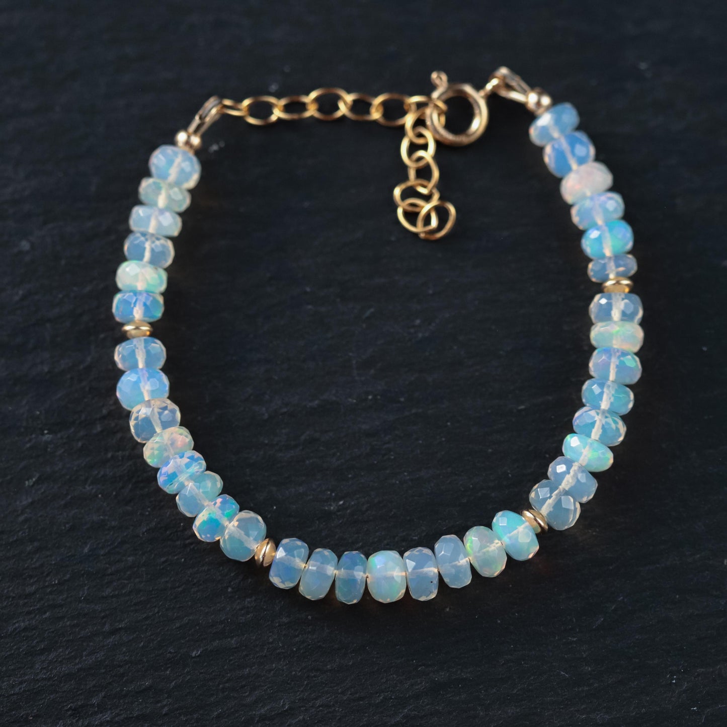 Ethiopian Welo Opal dainty bracelet with 14K gold chain, featuring vibrant opal gemstones and delicate design.