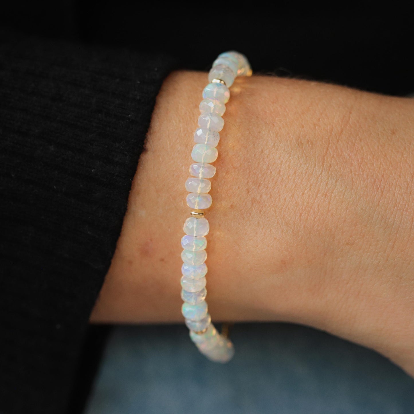 Ethiopian Welo Opal dainty bracelet with 14K gold setting, featuring colorful opal stones on a delicate chain.