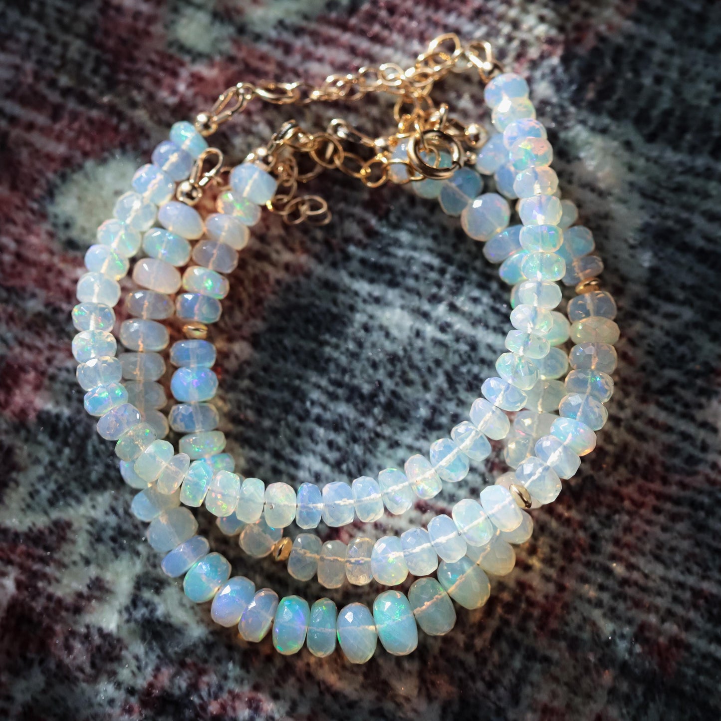 Ethiopian Welo Opal dainty bracelet with 14K gold setting featuring vibrant, iridescent opal gemstones on a delicate chain.