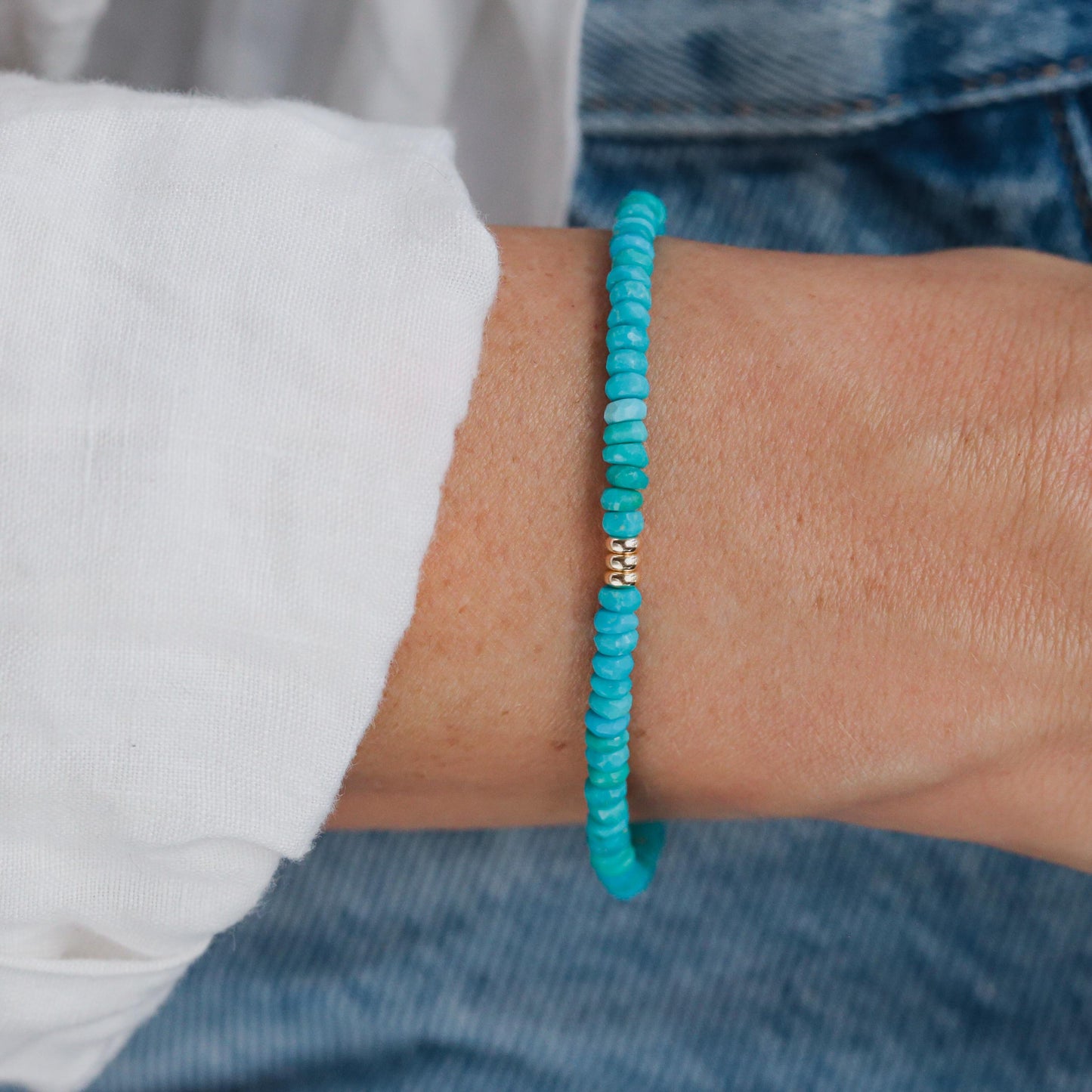 Sleeping Beauty turquoise bracelet with 14K gold setting, featuring vibrant blue turquoise stones and elegant jewelry design.