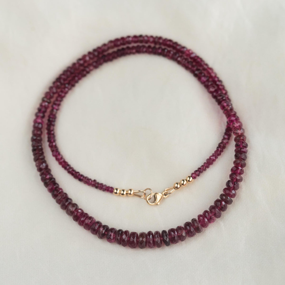 Rosé Ember Pink Tourmaline necklace with 14K gold chain from Earthly Abundance, featuring a vibrant pink gemstone pendant.