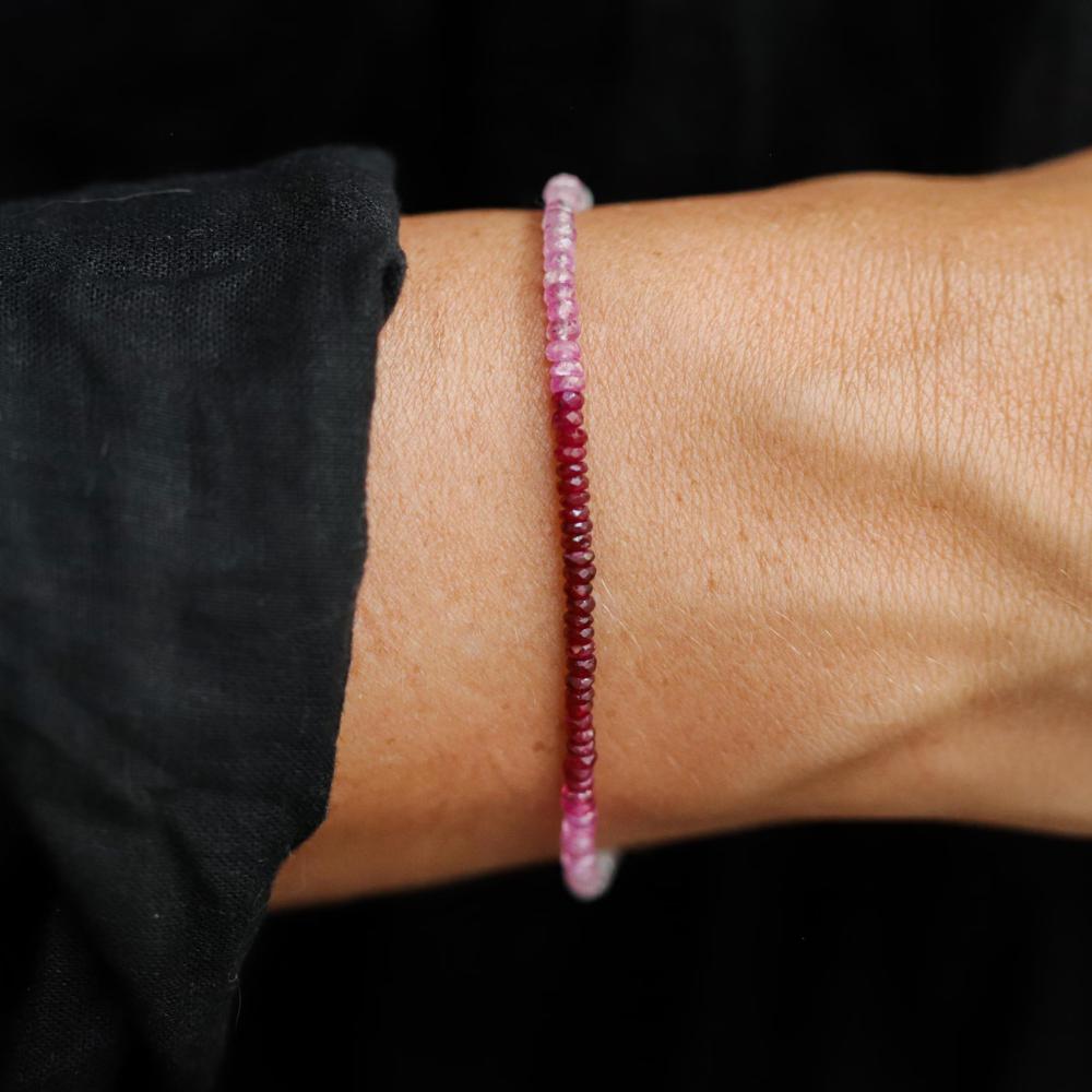 Raspberry Mist Ruby bracelet with 14K gold setting from Earthly Abundance, showcasing vibrant ruby beads and elegant design.