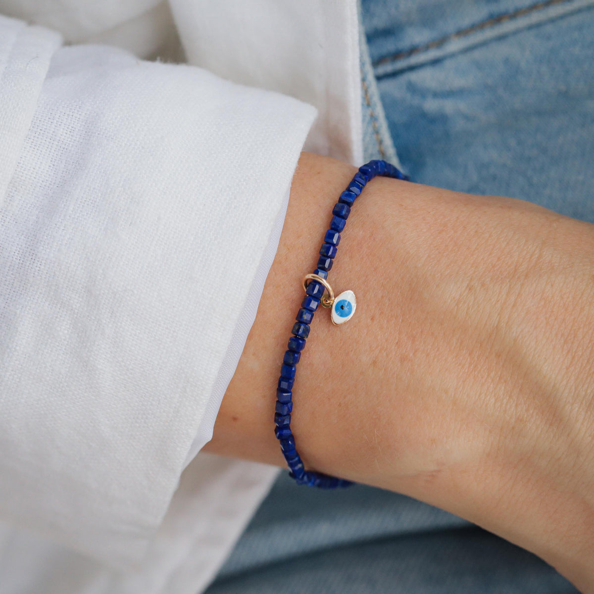 Lapis Lazuli Evil Eye pendant in 14K gold from Earthly Abundance, featuring a vibrant blue gemstone with protective evil eye design.