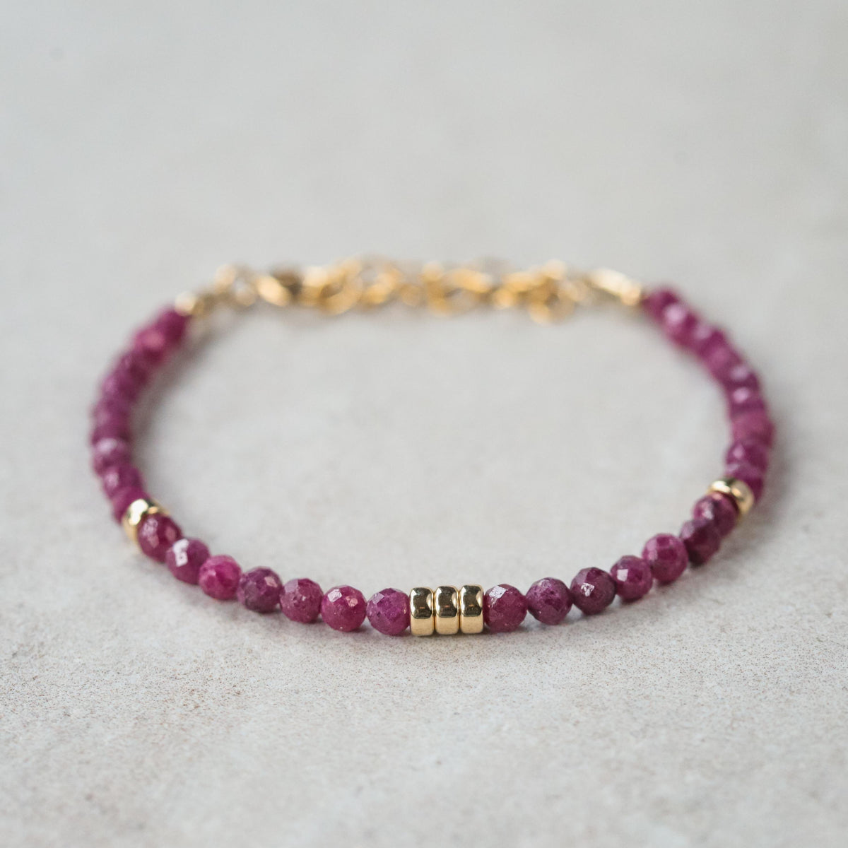 Elegant Wild Berry Ruby bracelet in 14K gold from Earthly Abundance featuring vibrant ruby stones and delicate gold links.