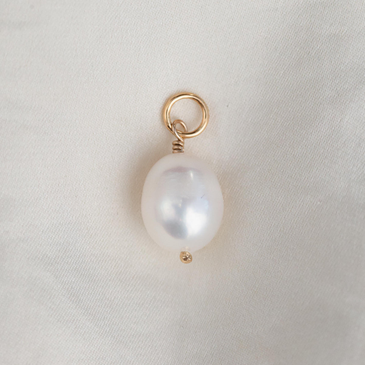Freshwater pearl pendant in 14K gold from Earthly Abundance, featuring a smooth, lustrous pearl hanging from a delicate gold chain.