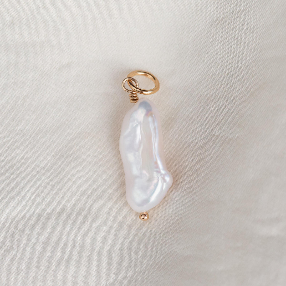 Freshwater pearl pendant in 14K gold from Earthly Abundance featuring a lustrous white pearl on a delicate chain.