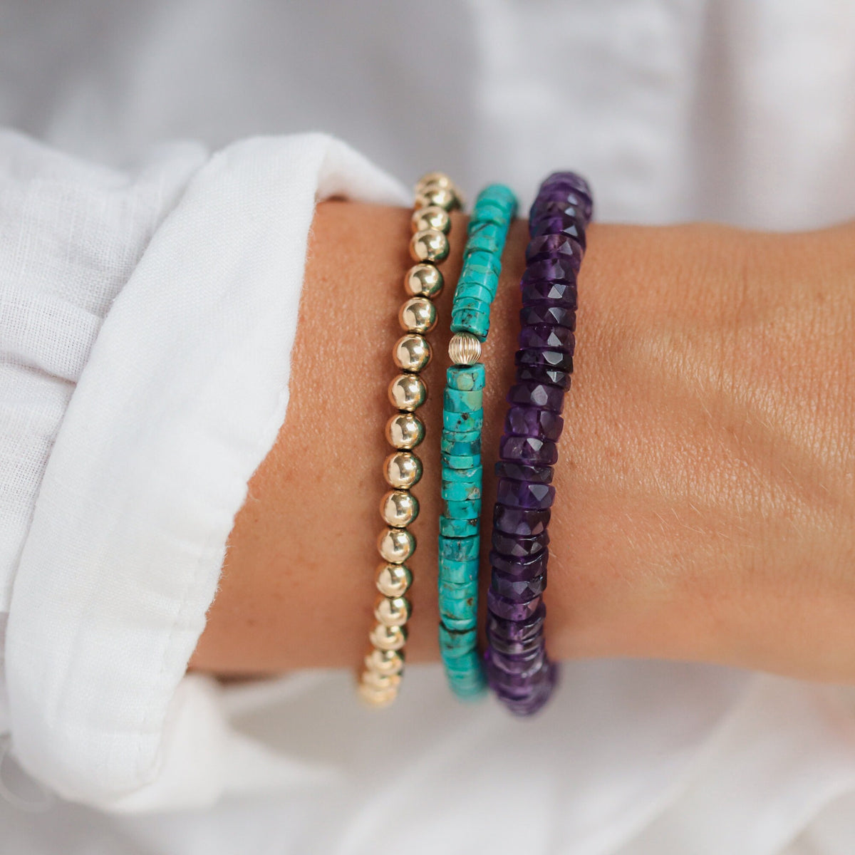 Earthly Abundance Amethyst Heishi bracelet featuring small purple gemstone beads on an elastic band.