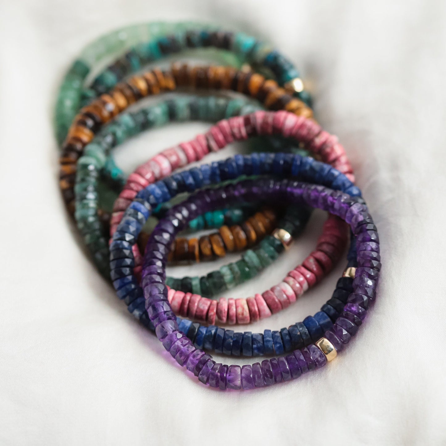 Earthly Abundance Amethyst Heishi bracelet featuring small purple gemstone beads on a stretch elastic band.
