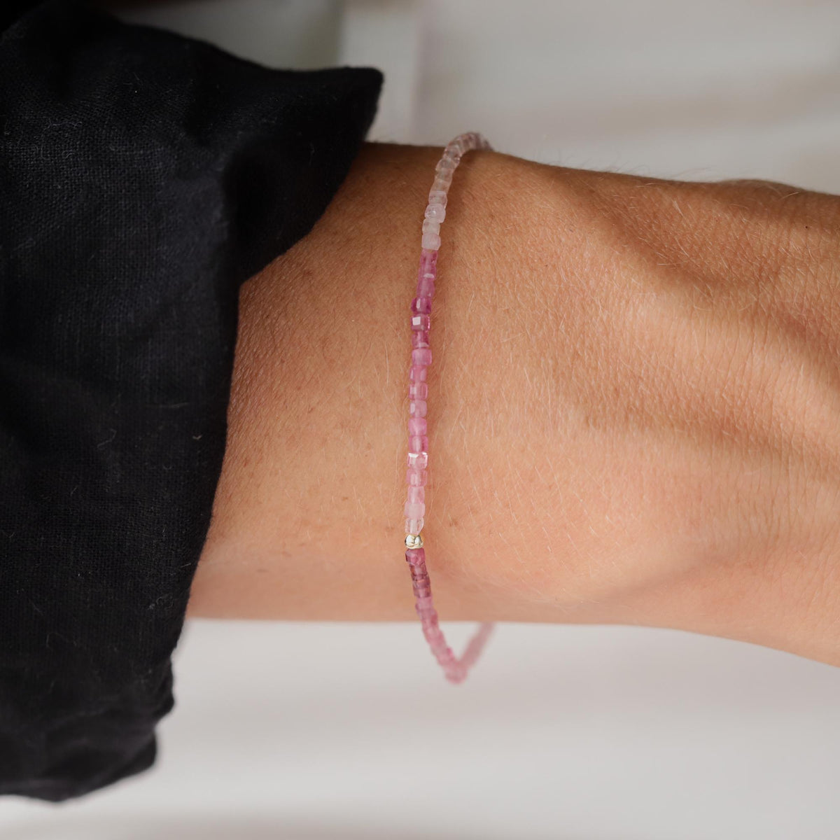 Pink tourmaline cube bracelet with 14K gold setting, featuring faceted pink gemstones on a delicate gold chain.