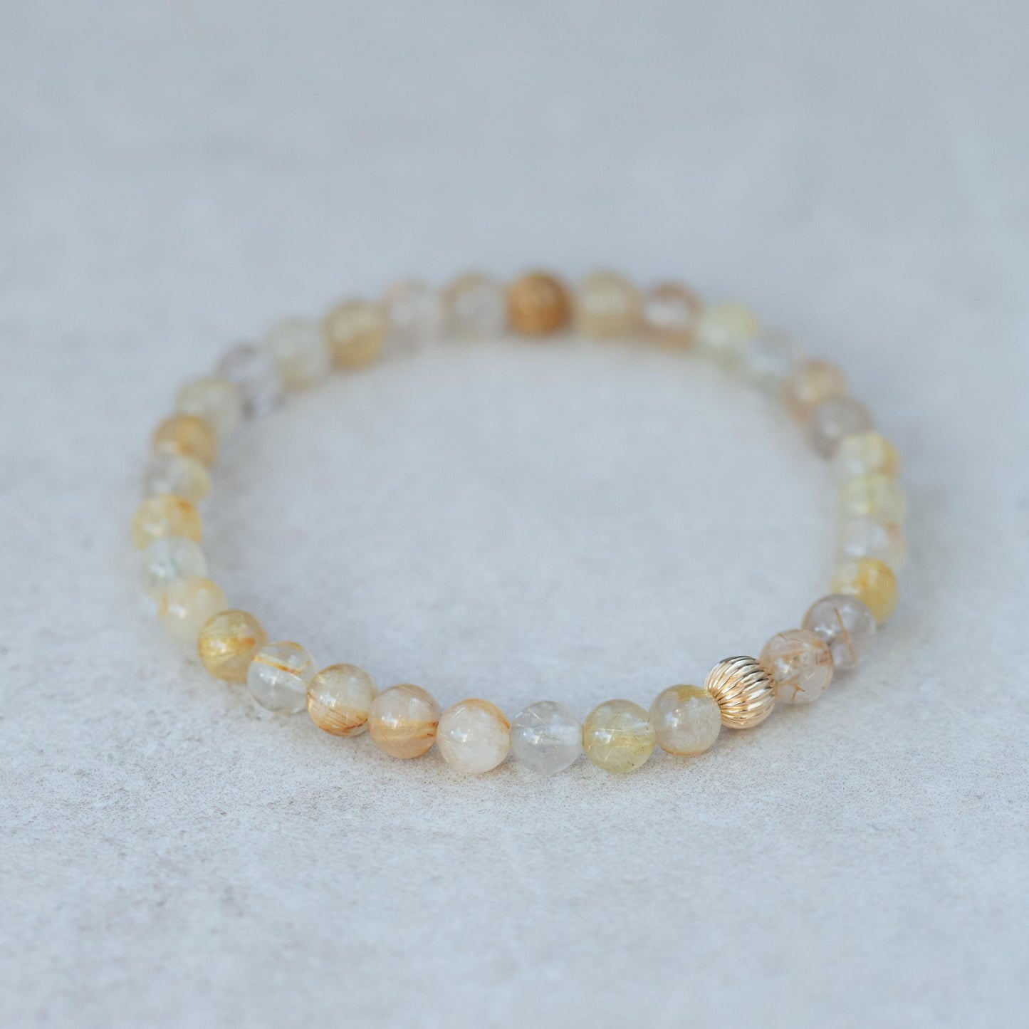 Golden Rutilated Quartz gemstone in a 14K setting, showcasing golden rutile inclusions and a polished, elegant appearance.