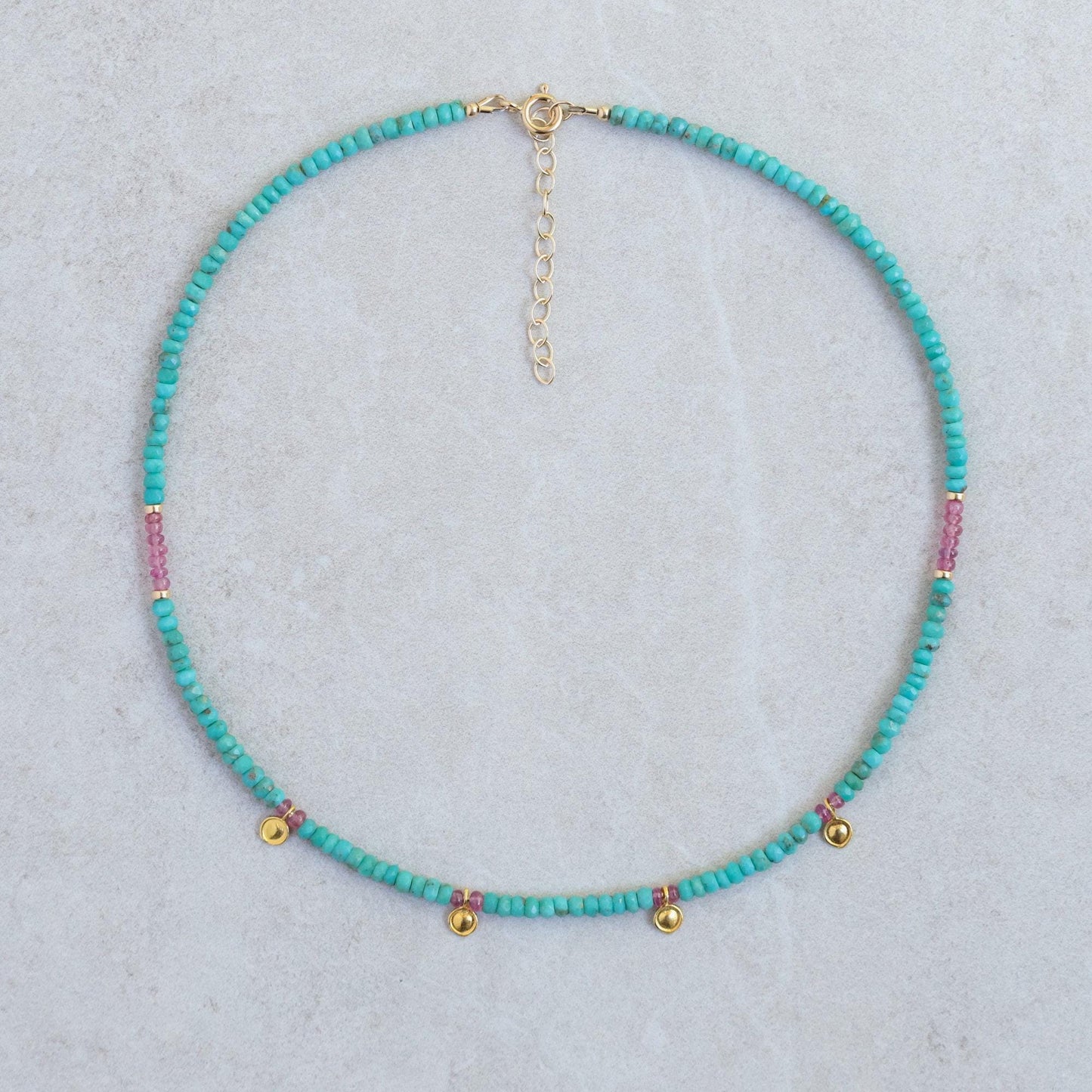Turquoise and pink sapphire necklace with silver chain, featuring vibrant gemstones and elegant design by Earthly Abundance.