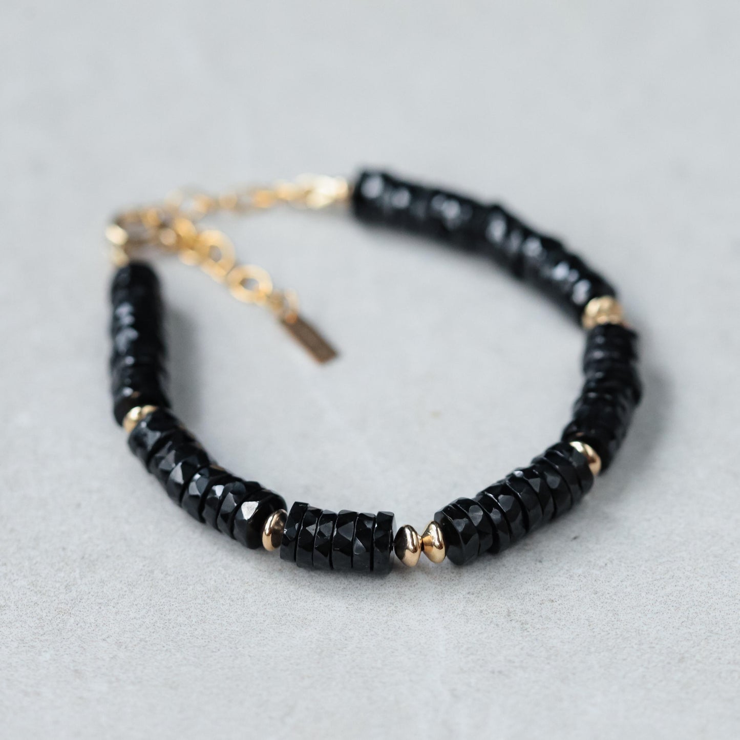 Black Tourmaline Heishi bracelet with small round beads, strung on elastic cord, from Earthly Abundance.