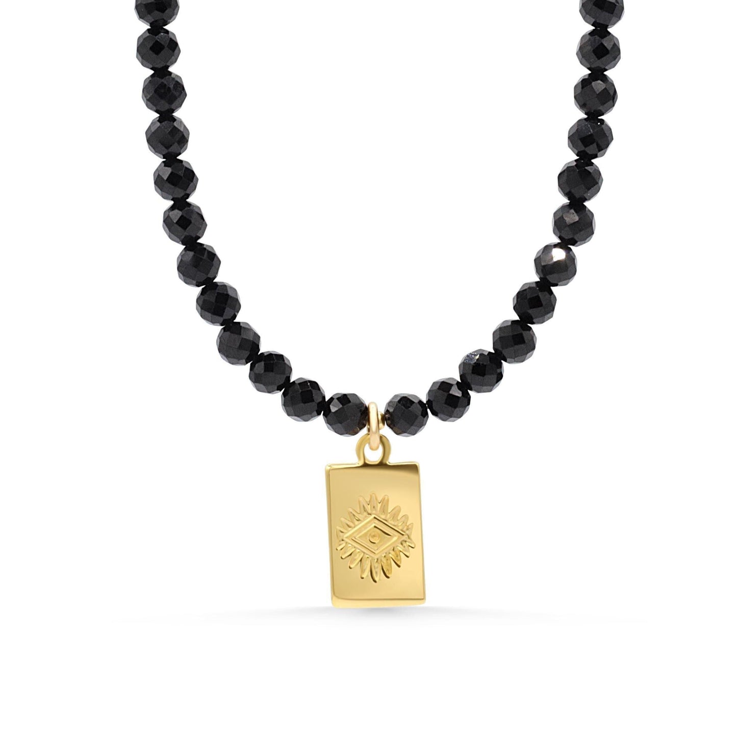 Black tourmaline evil eye necklace with a protective pendant on a silver chain, designed by Earthly Abundance.