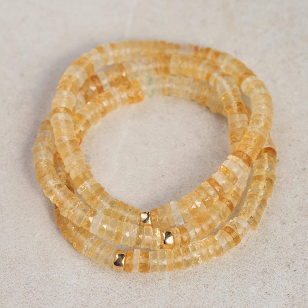 Citrine Heishi bracelet by Earthly Abundance featuring small, smooth yellow gemstone beads on a stretch cord.