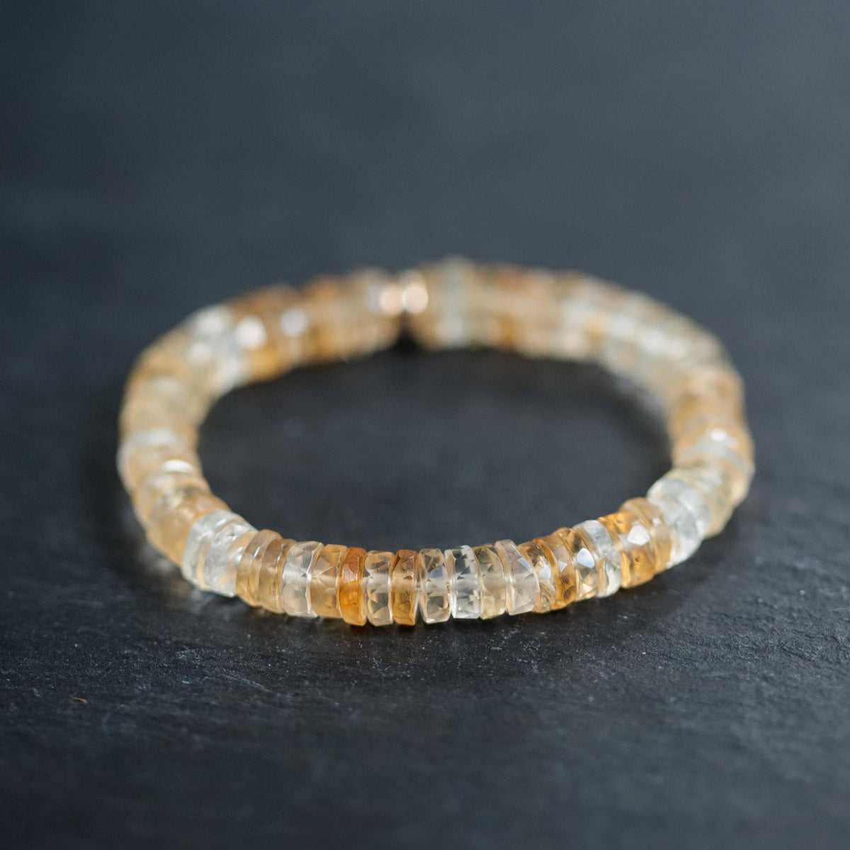 Citrine Heishi bracelet by Earthly Abundance featuring small, orange-yellow gemstone beads on a stretchy elastic band.