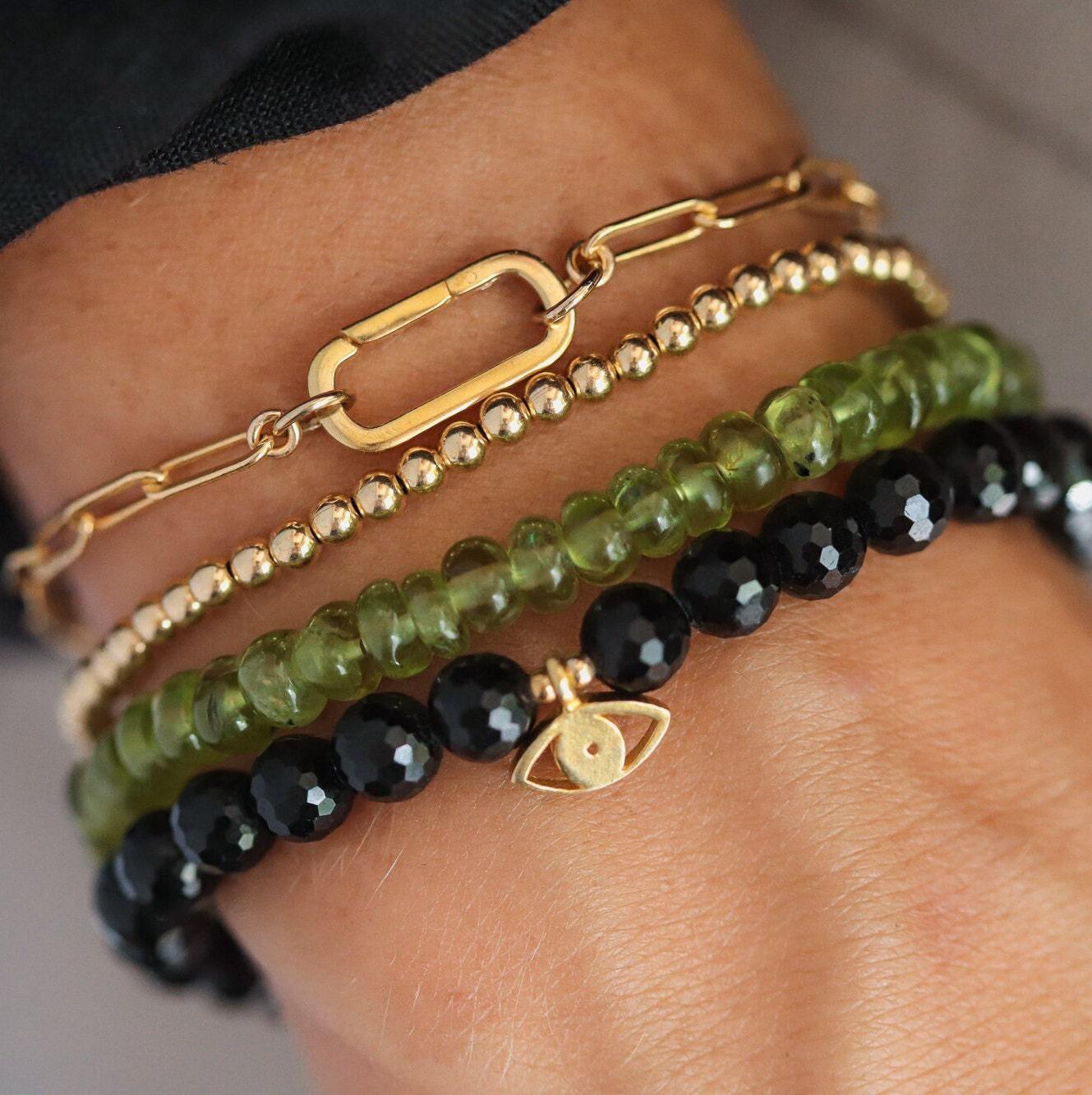Black Tourmaline Evil Eye pendant from Earthly Abundance featuring a protective evil eye charm and polished black tourmaline gemstone.