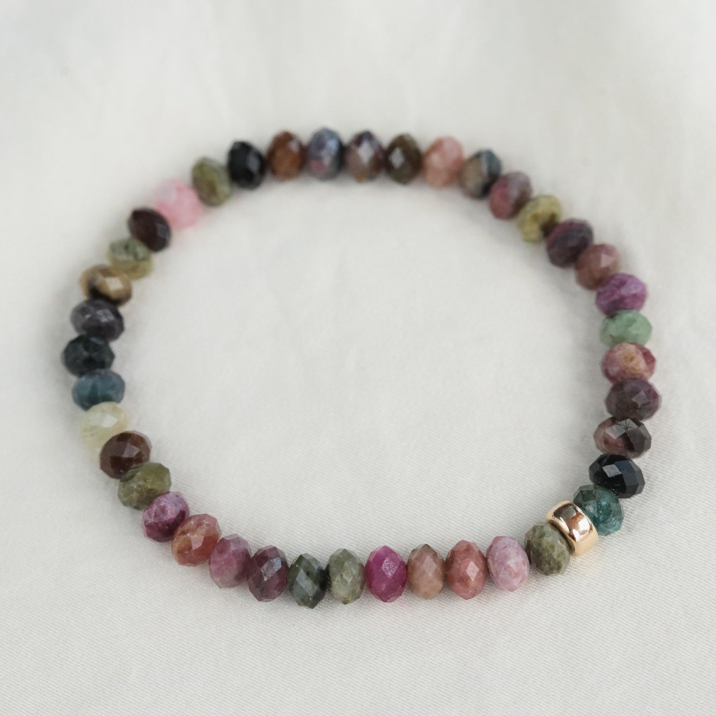 Mixed tourmaline bracelet featuring colorful gemstone beads from Earthly Abundance, styled on a wrist.