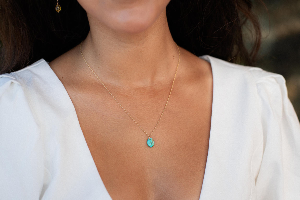 Turquoise necklace from Earthly Abundance featuring vibrant blue beads and silver accents on a delicate chain.