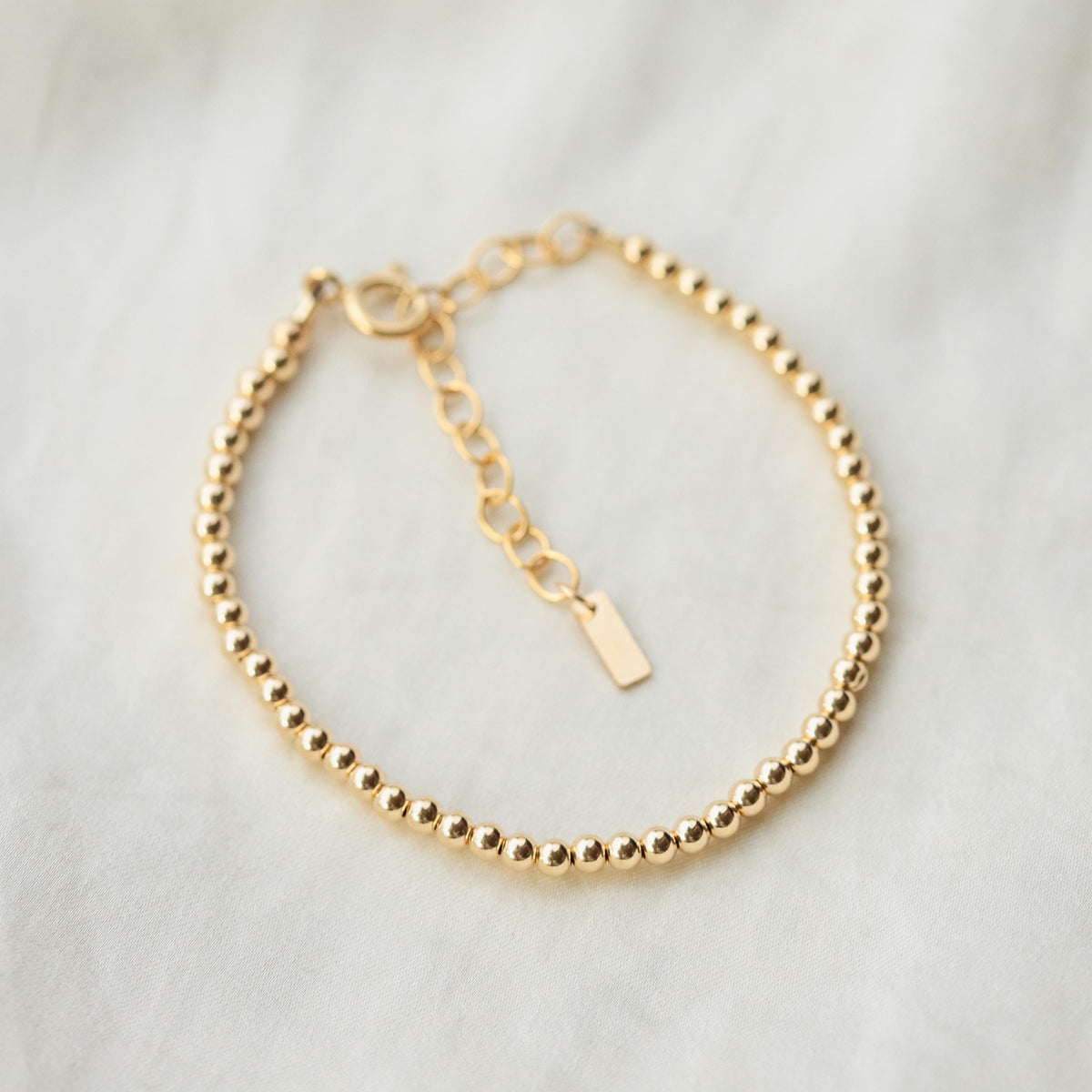 Adjustable gold filled beaded ball bracelet by Earthly Abundance featuring small round beads on a delicate chain.