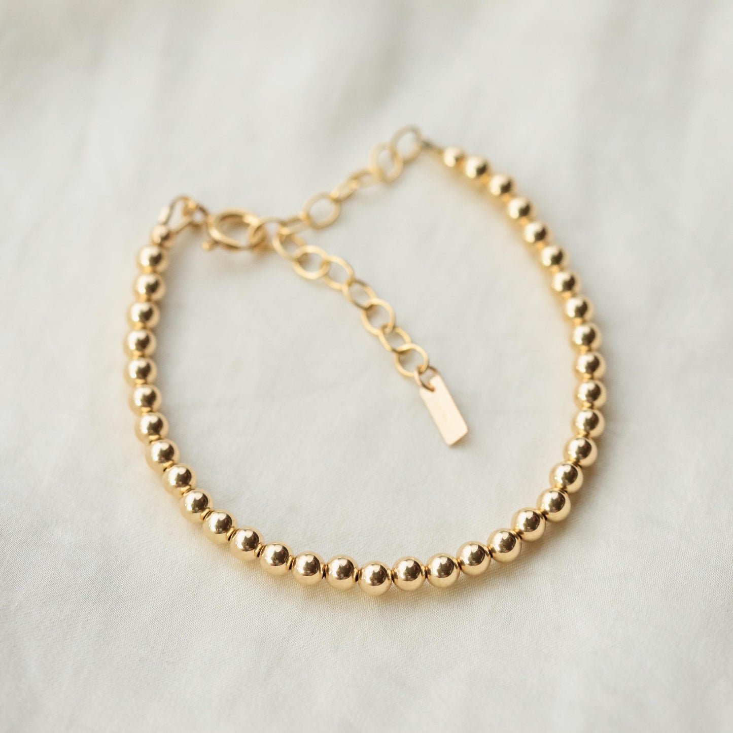 Adjustable gold-filled beaded ball bracelet with small round beads, stylish jewelry from Earthly Abundance.
