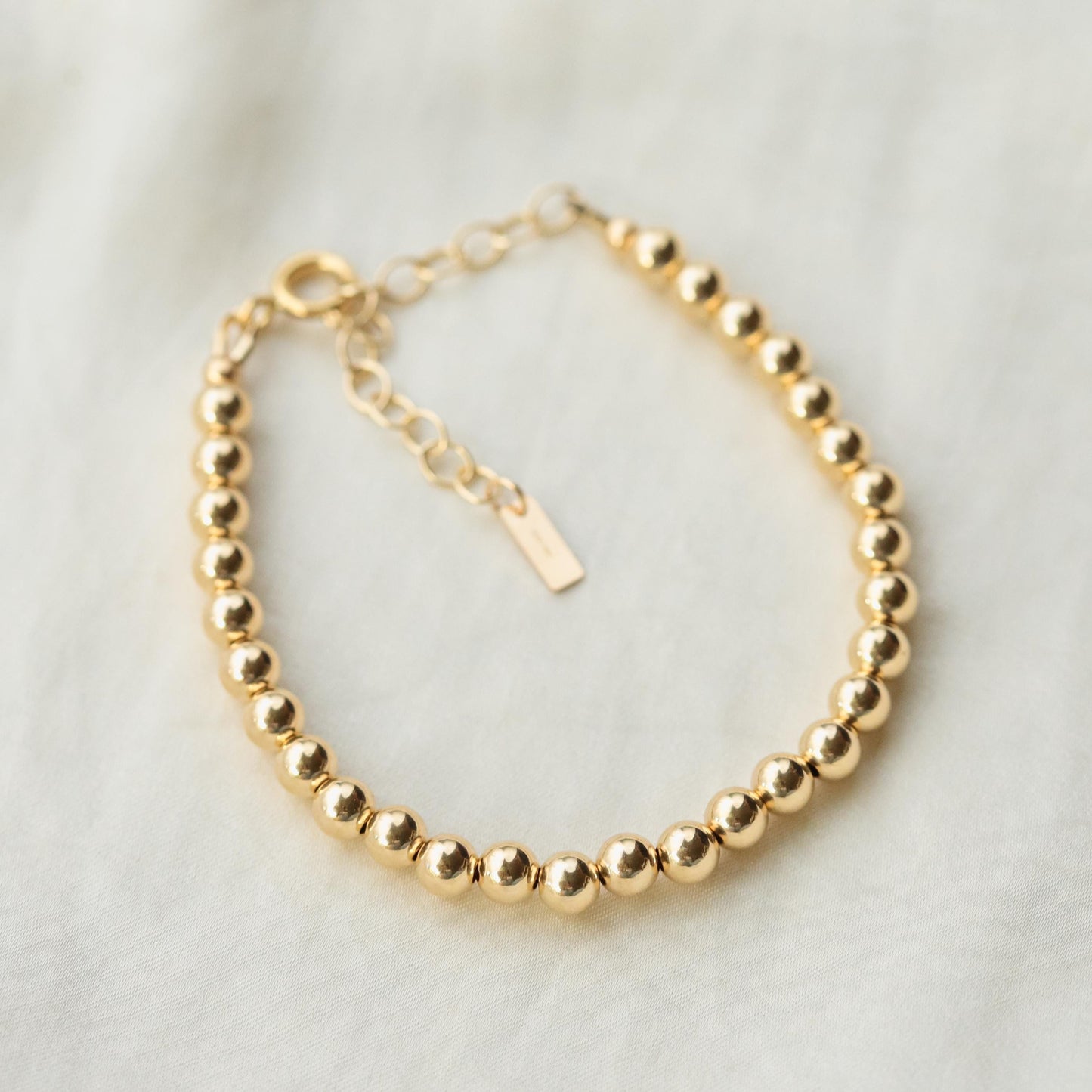 Adjustable gold-filled beaded ball bracelet from Earthly Abundance featuring small round beads on a delicate chain.