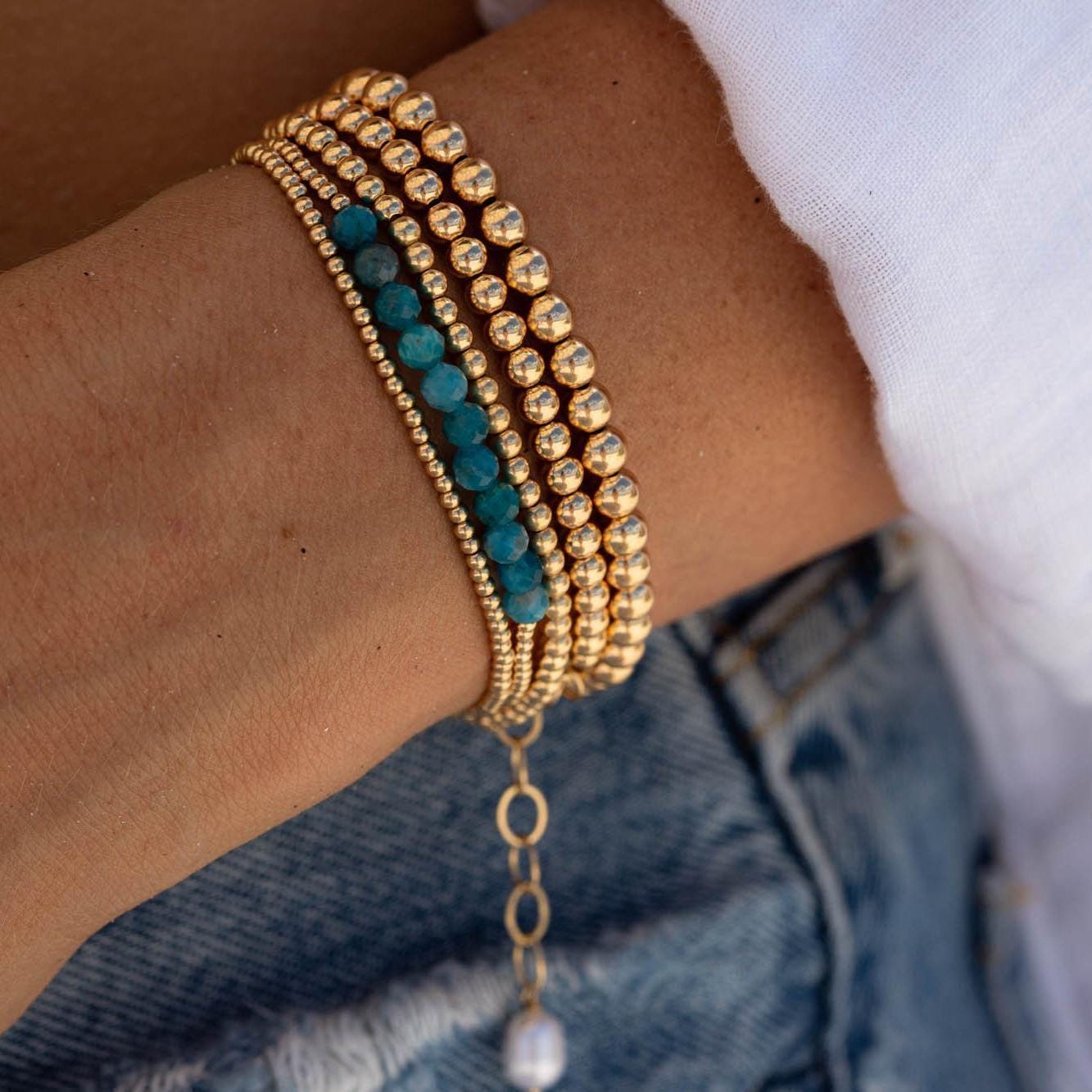 Adjustable gold-filled beaded ball bracelet with small round beads, featuring a secure clasp, from Earthly Abundance.