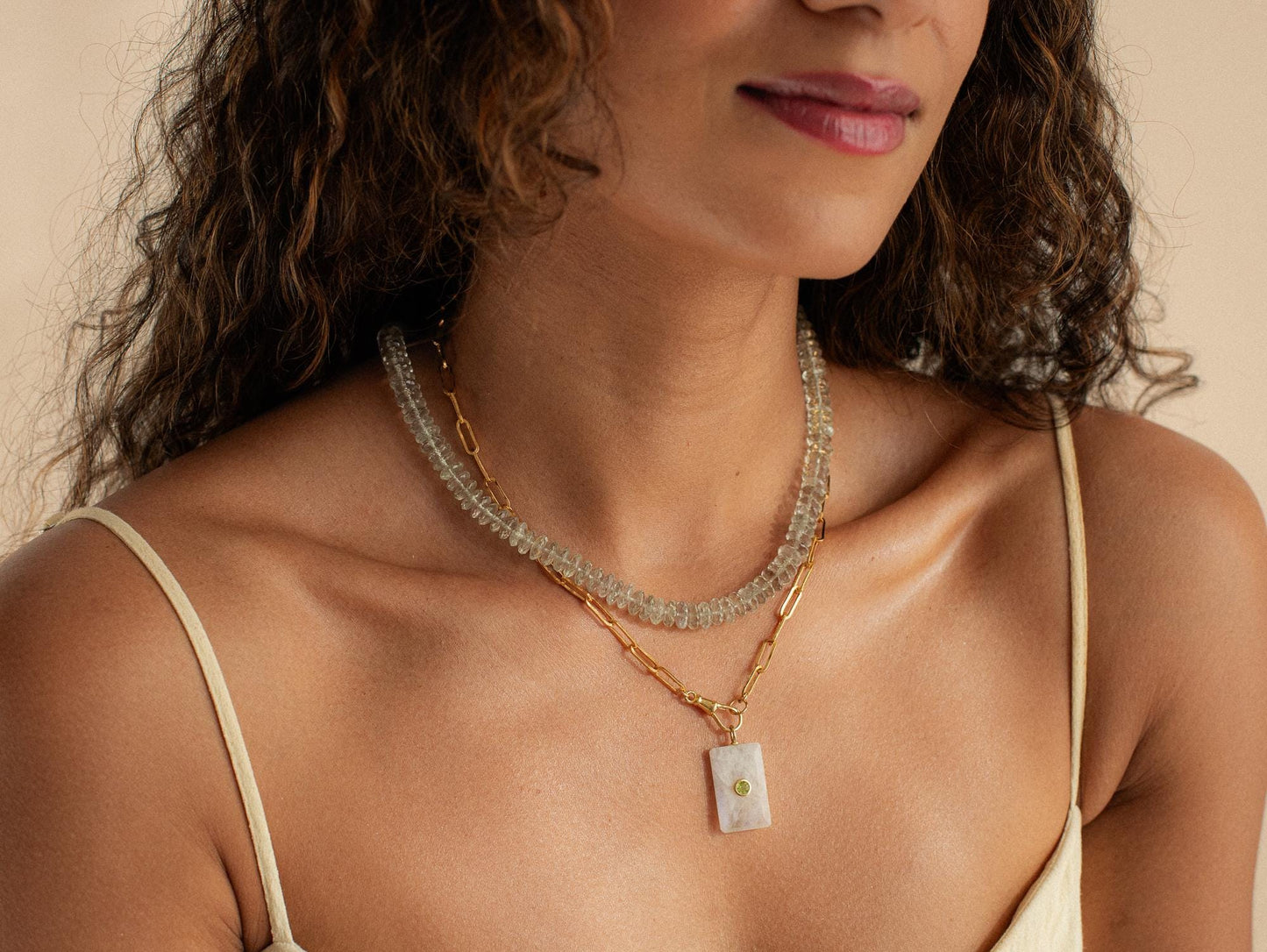 Green amethyst necklace with 14K gold chain from Earthly Abundance, featuring a polished green gemstone pendant.