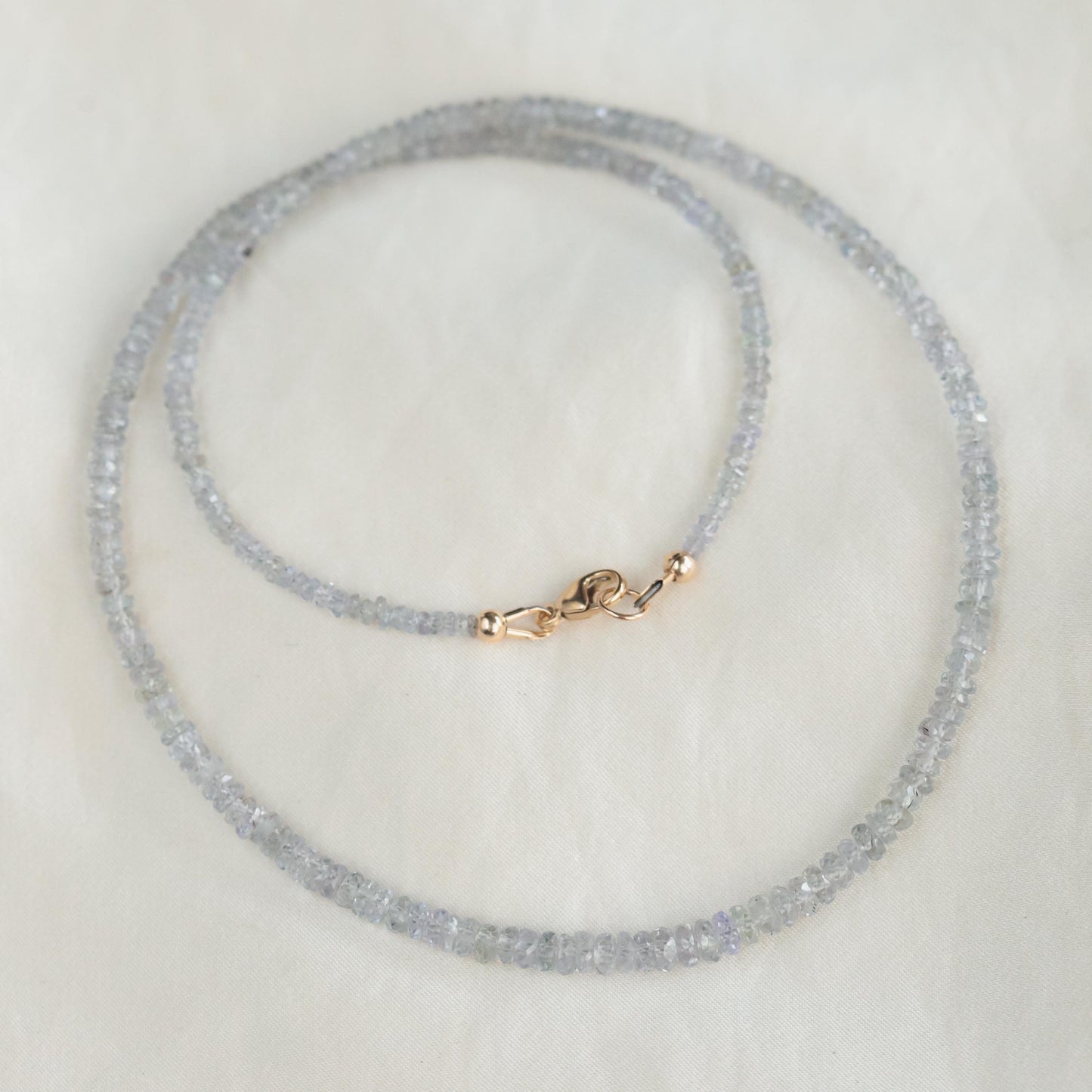Grey sapphire necklace in 14K gold with a delicate chain, showcasing a sparkling grey sapphire pendant.