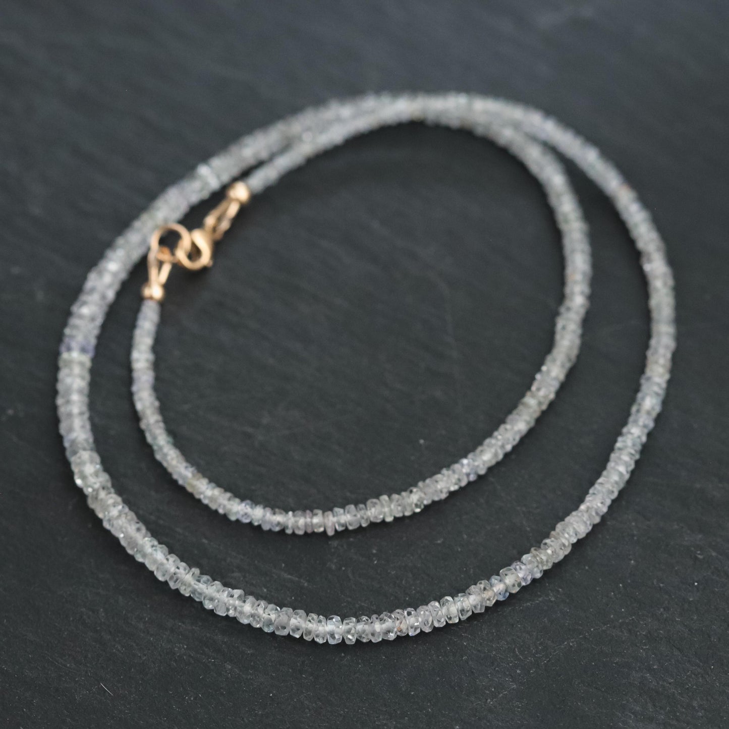 Grey sapphire necklace in 14K gold with a delicate chain and a central grey sapphire gemstone, elegant jewelry piece.