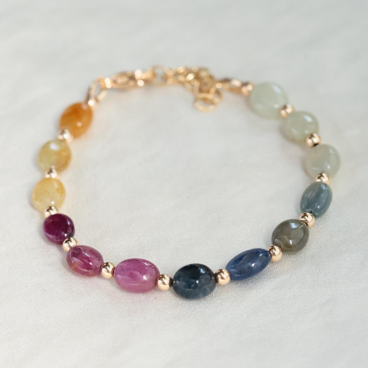 Multi sapphire oval bracelet by Earthly Abundance featuring vibrant oval-shaped sapphires and a delicate silver chain.