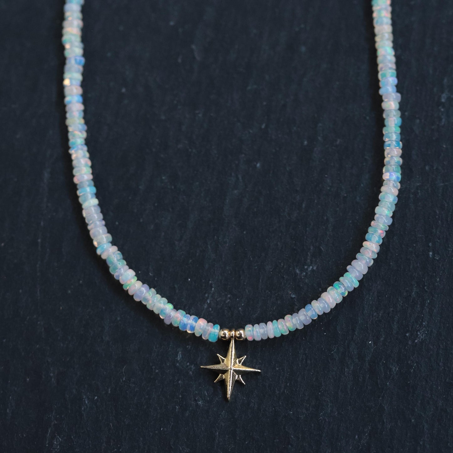 Ethiopian Opal North Star Necklace in 14K gold from Earthly Abundance featuring a sparkling star-shaped opal pendant.