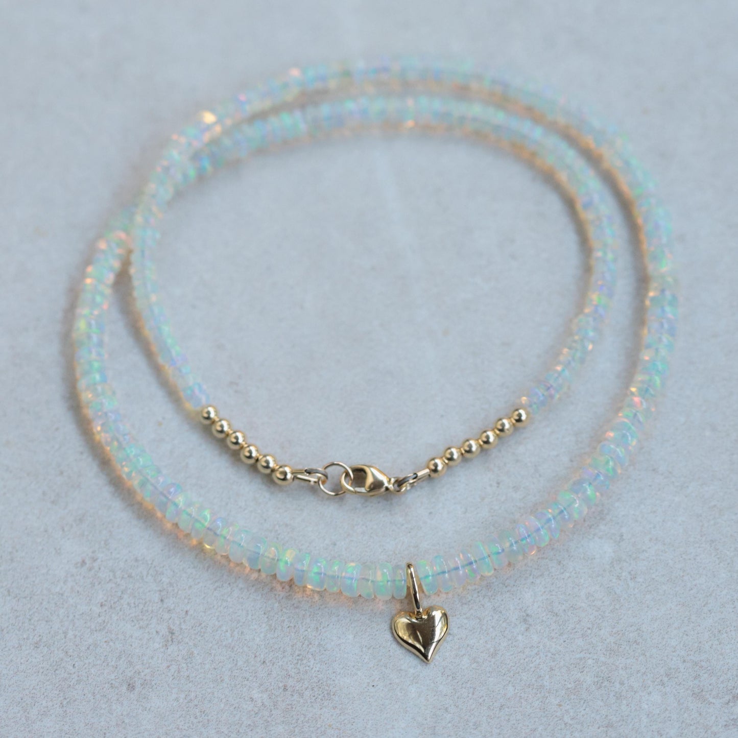 Ethiopian Opal Heart Necklace in 14K gold, featuring a vibrant, translucent heart-shaped opal pendant on a delicate chain.