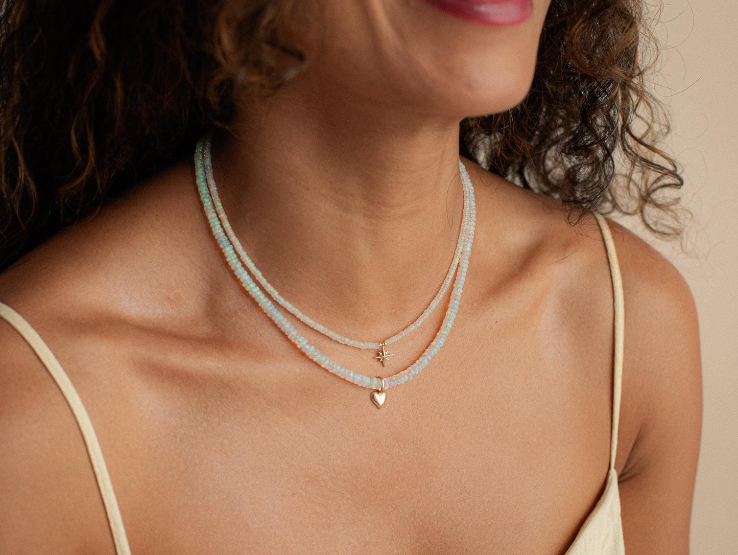 Ethiopian Opal Heart Necklace in 14K gold from Earthly Abundance, featuring a sparkling heart-shaped opal pendant.