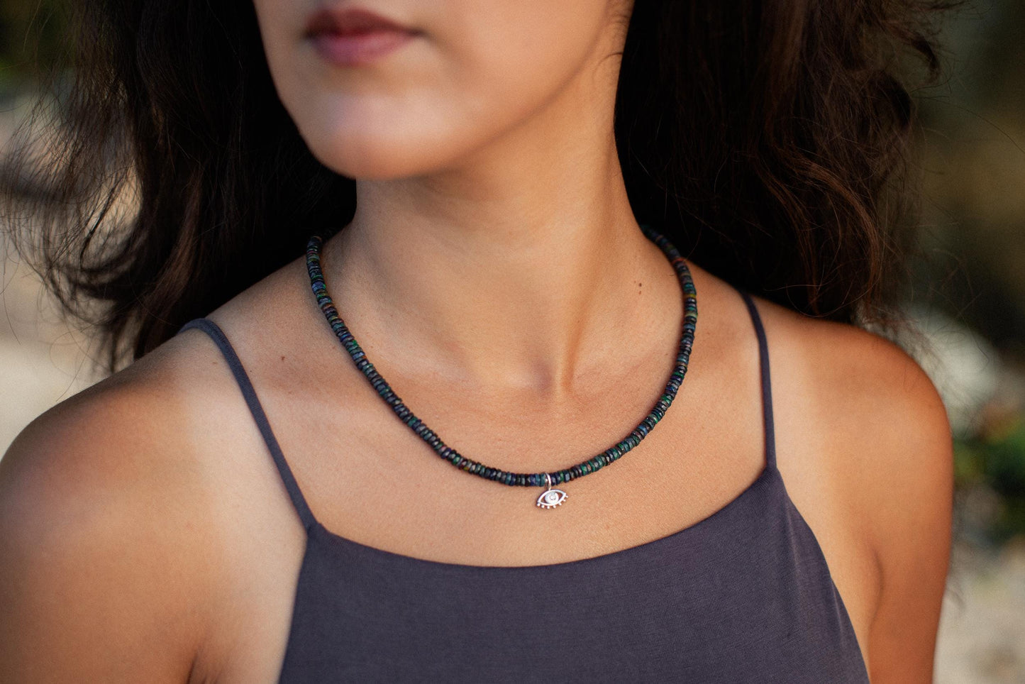 Black Ethiopian Opal Diamond Evil Eye pendant with intricate silver setting, featuring vibrant opal and sparkling diamonds.