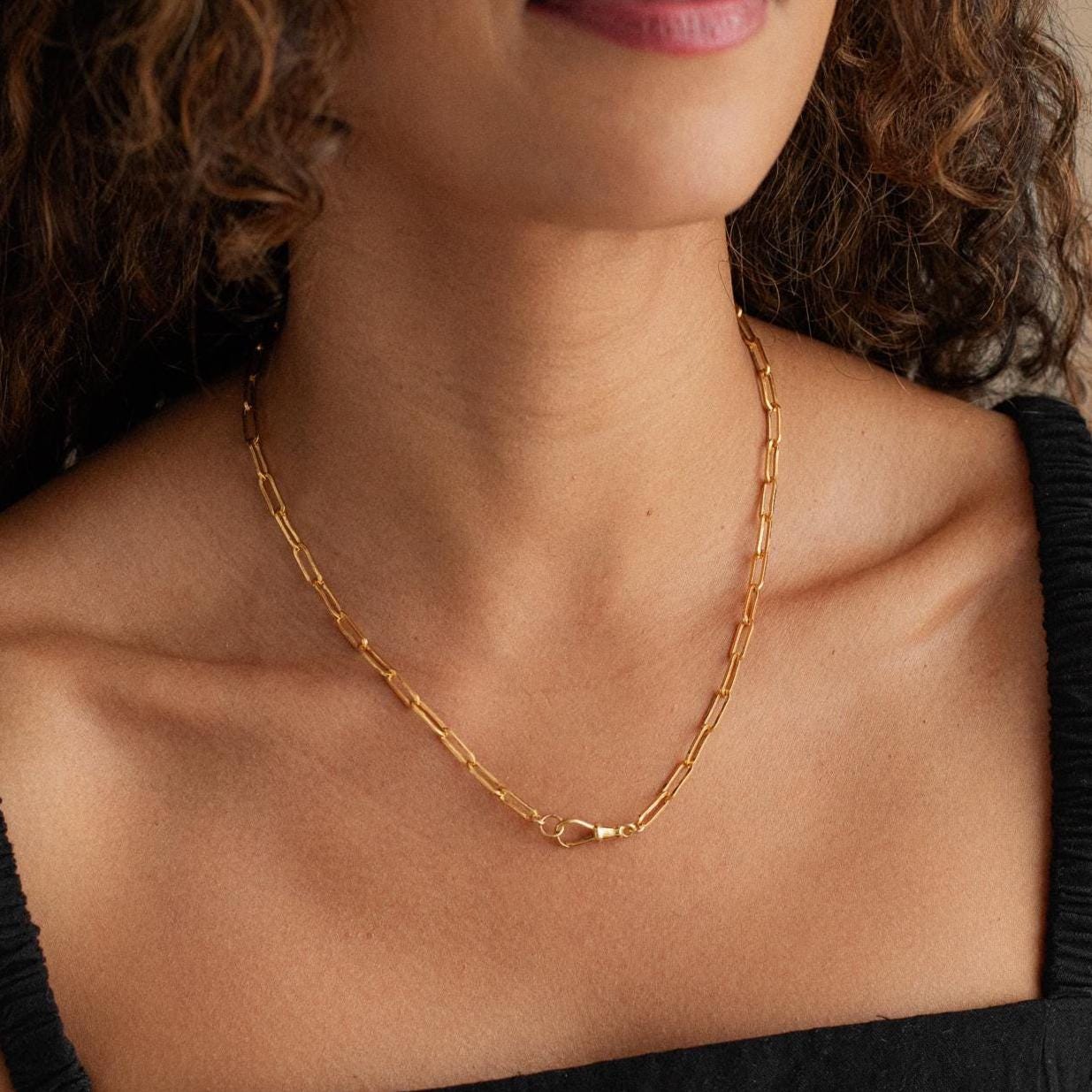 14K gold filled swivel paperclip chain by Earthly Abundance, featuring interconnected elongated oval links on a white background.