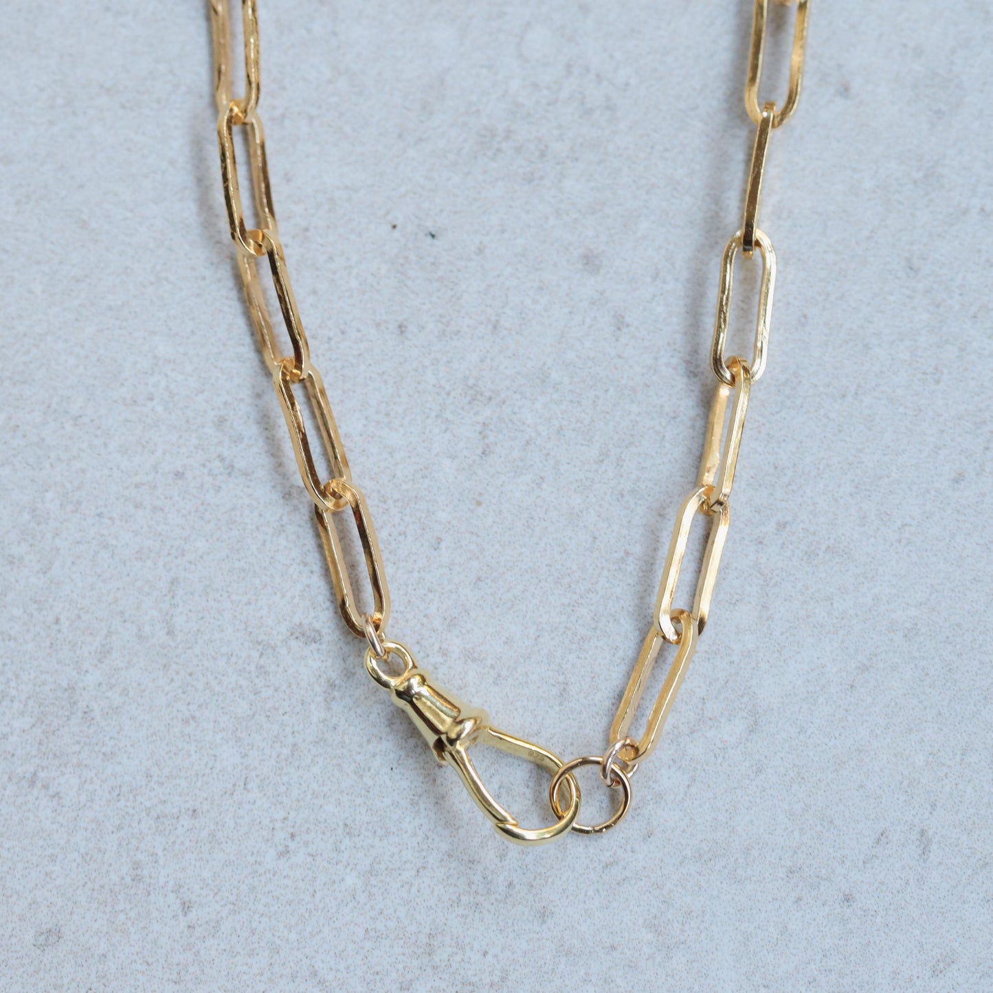 14K gold-filled swivel paperclip chain from Earthly Abundance, showcasing a shiny, interconnected chain design.