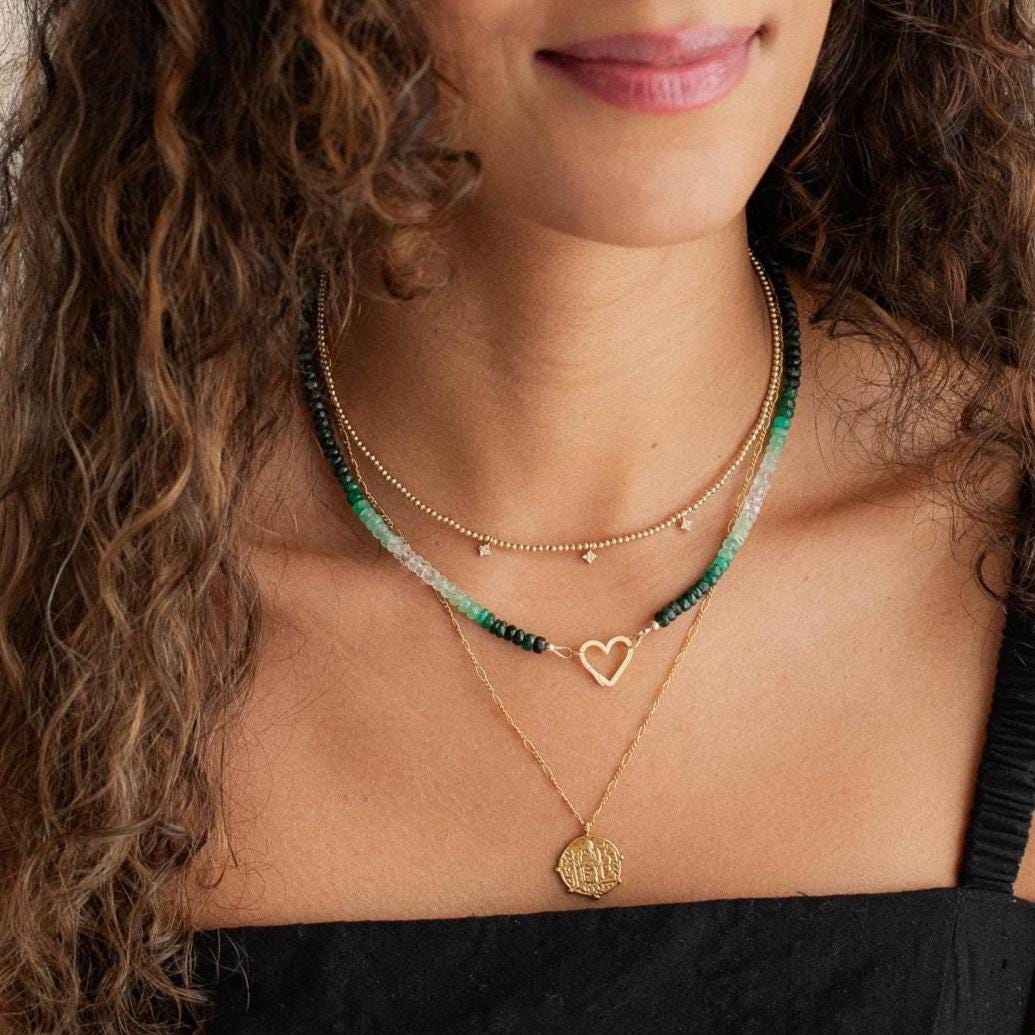 Emerald heart-shaped 14K gold carabiner necklace with a delicate chain from Earthly Abundance.