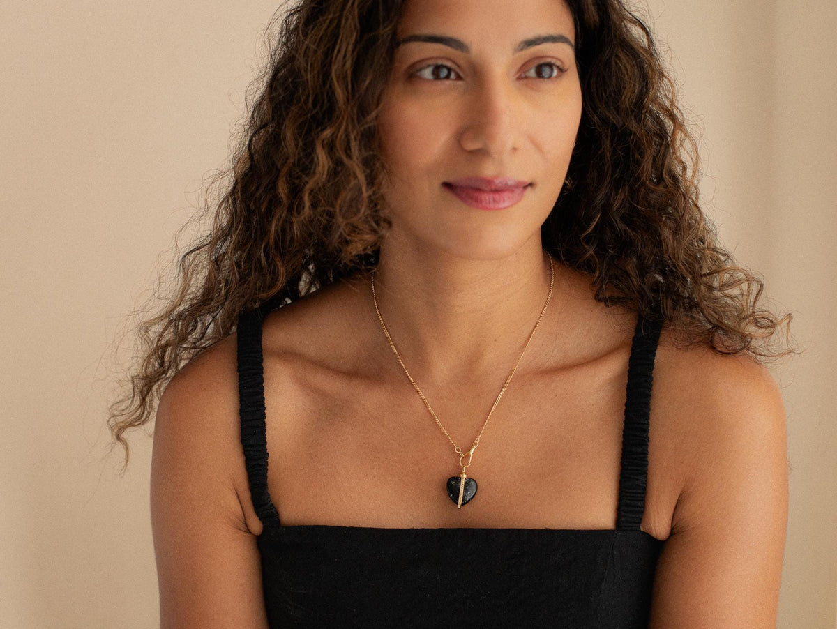 Black Tourmaline Heart Pendant from Earthly Abundance featuring a polished black stone heart on a silver chain.