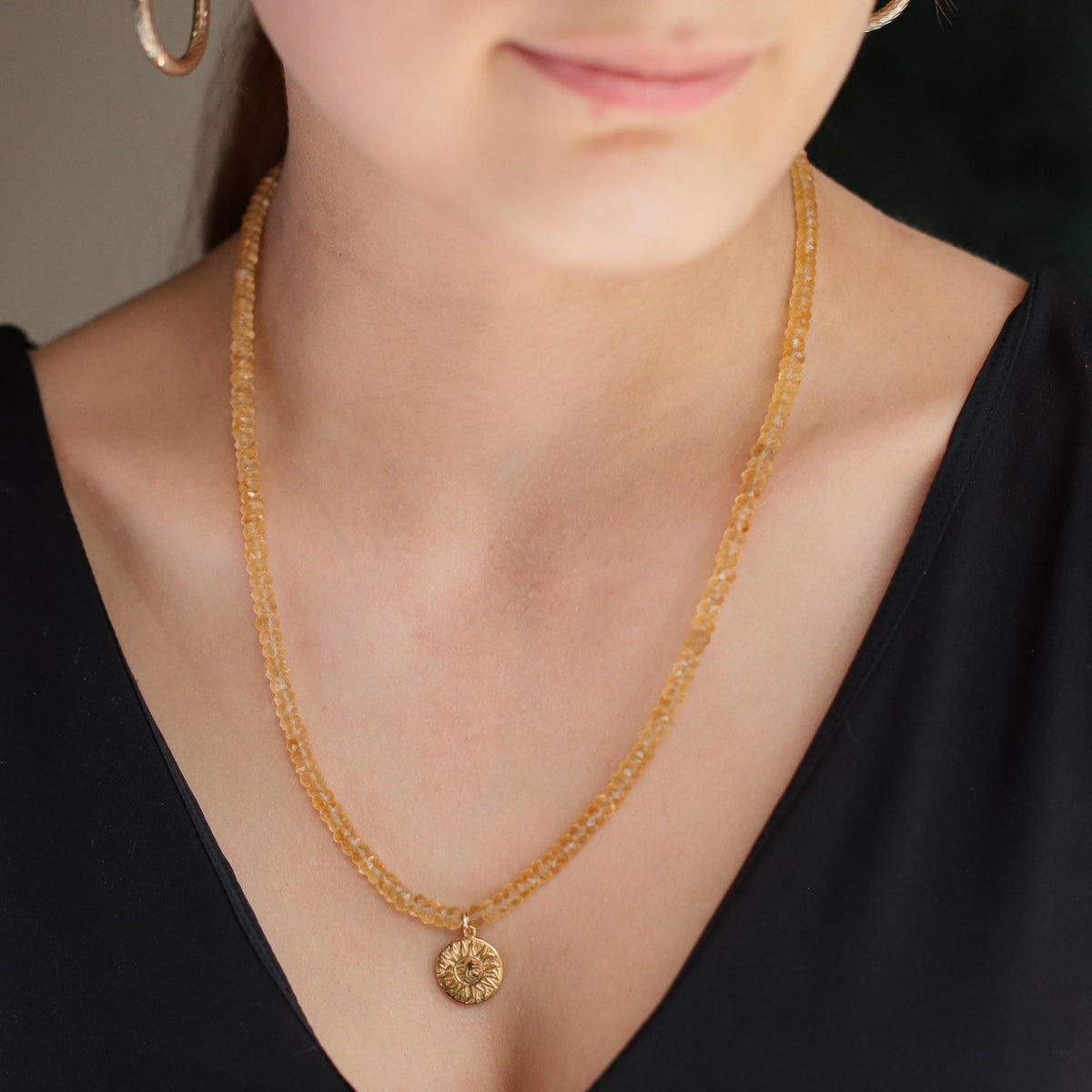 Citrine Sun Necklace by Earthly Abundance featuring a radiant sun-shaped pendant with a large yellow citrine gemstone.