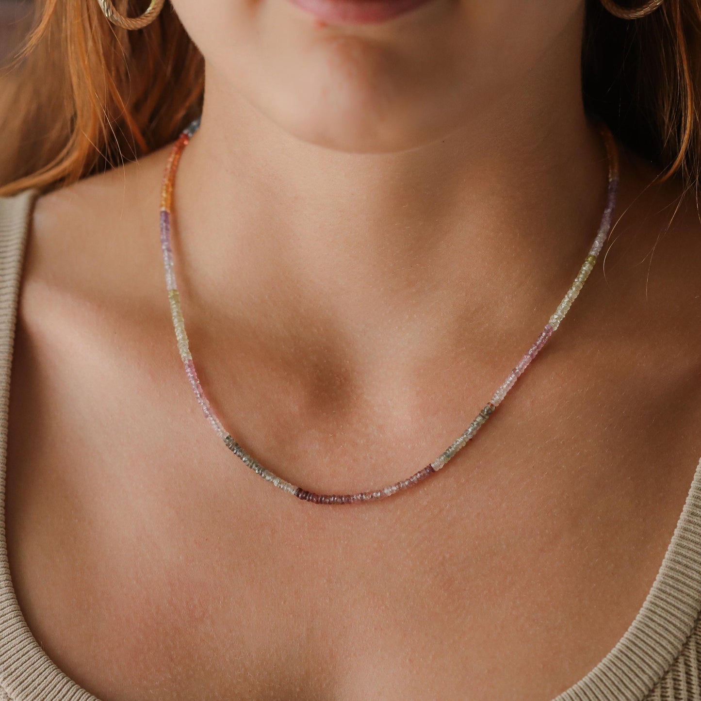 Multi sapphire carabiner necklace by Earthly Abundance featuring vibrant sapphires and a sleek metal chain.