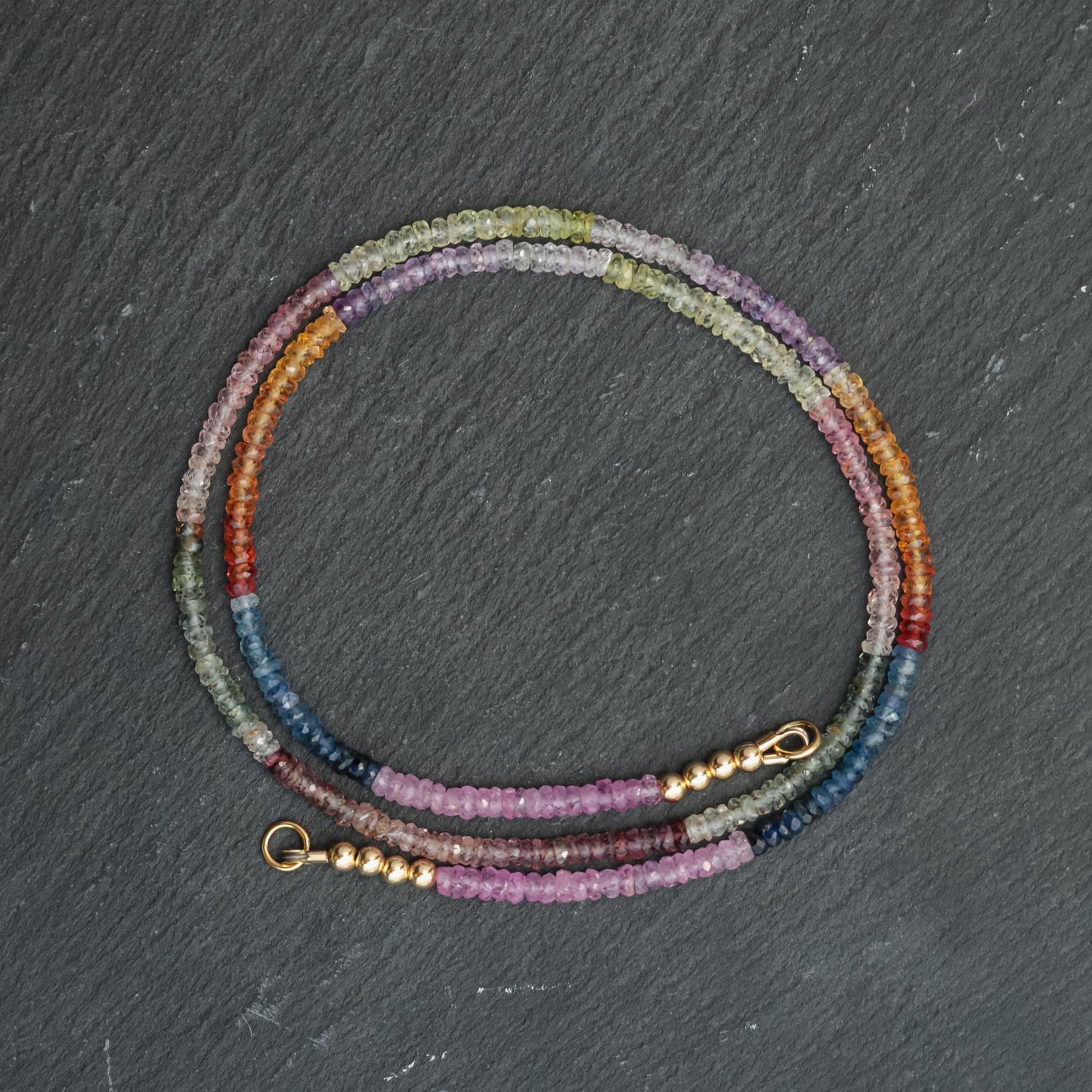 Multi sapphire carabiner necklace by Earthly Abundance featuring colorful gemstone accents on a metal chain.