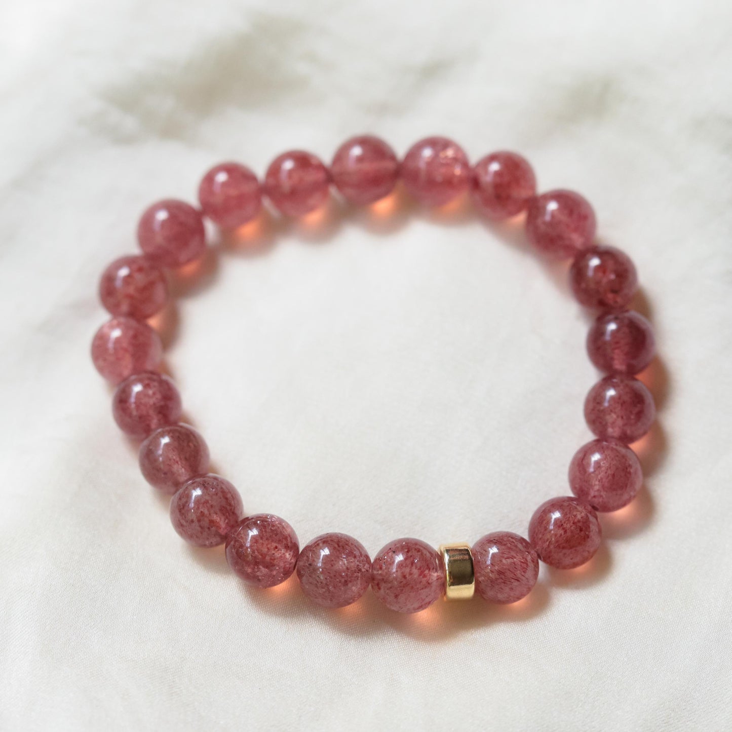 Strawberry Quartz gemstone pendant set in 14K gold with a delicate chain, showcasing vibrant pink hues and natural clarity.