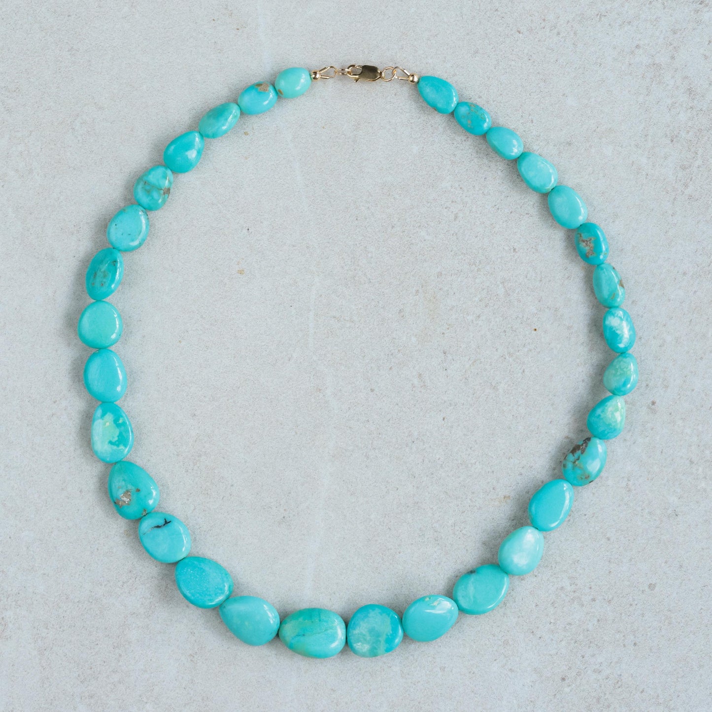 Turquoise Sol Necklace in 14K gold from Earthly Abundance featuring a vibrant turquoise pendant on a delicate gold chain.